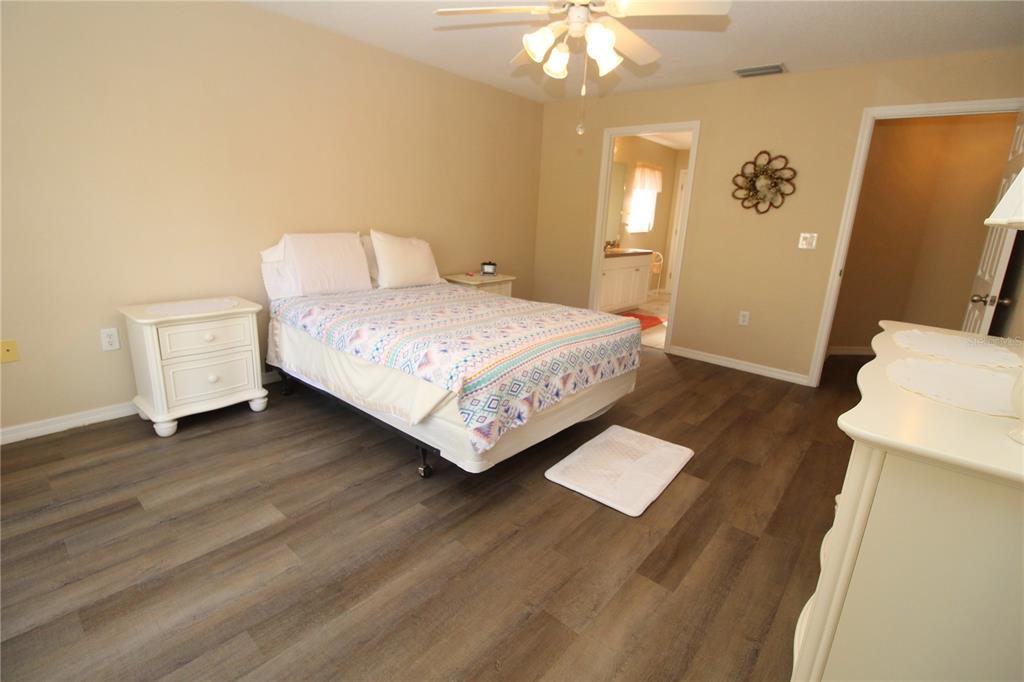 7432 Perennial Road North Port, FL 34291 - Photo 31 of 61 a bedroom with a bed and wooden floor