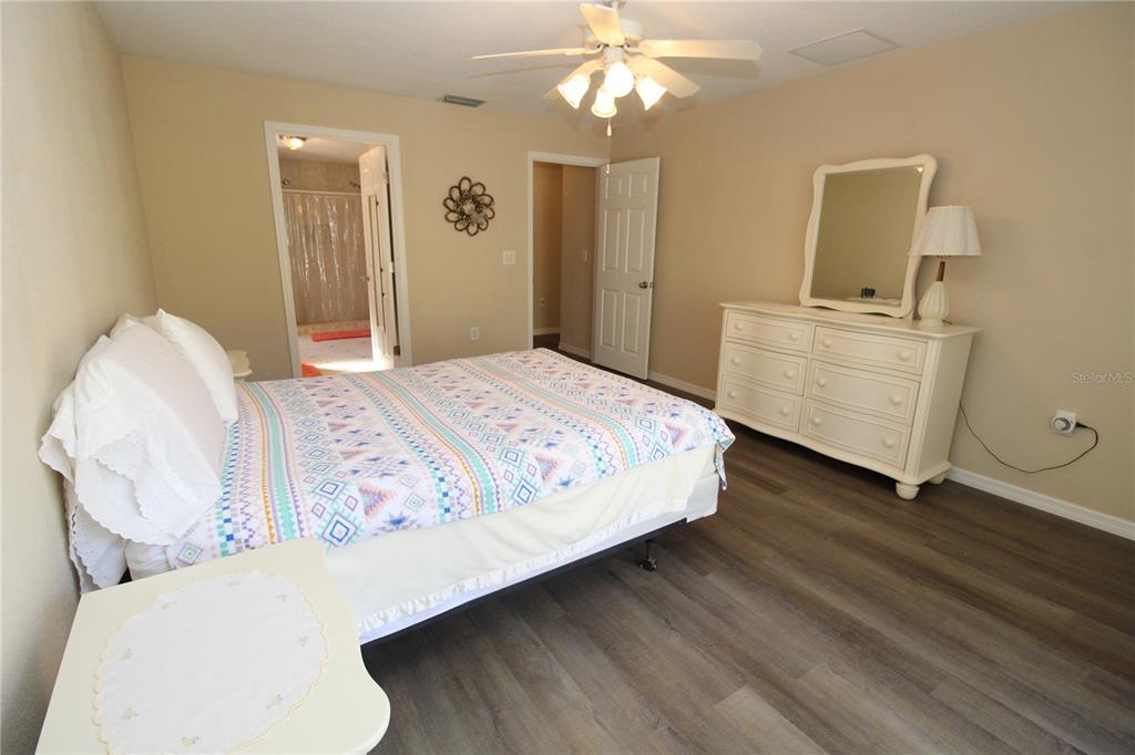 7432 Perennial Road North Port, FL 34291 - Photo 32 of 61 a bedroom with a bed and dresser