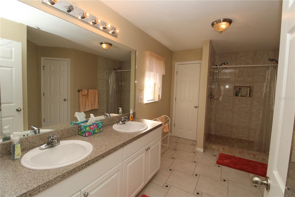 7432 Perennial Road North Port, FL 34291 - Photo 33 of 61 a bathroom with a sink double vanity and shower