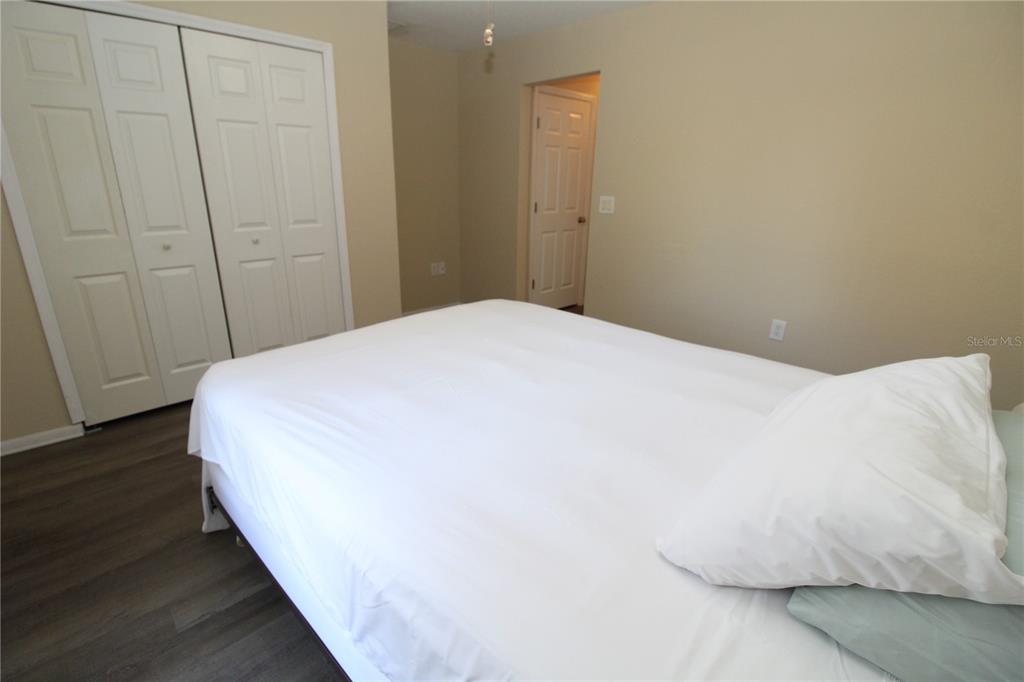 7432 Perennial Road North Port, FL 34291 - Photo 39 of 61 a large bed in a bedroom next to a wooden door