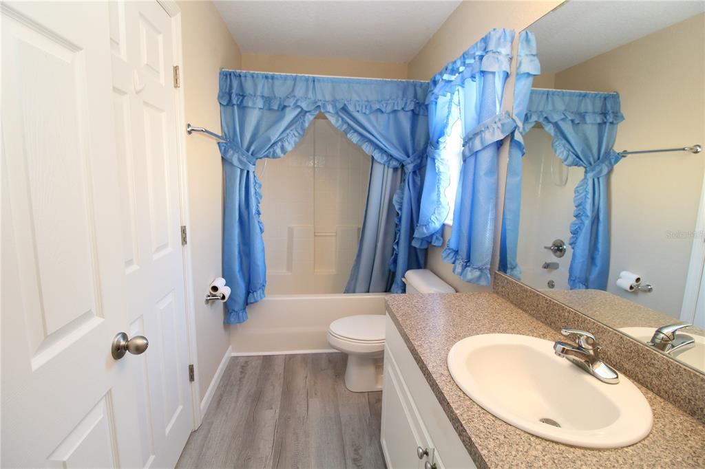 7432 Perennial Road North Port, FL 34291 - Photo 45 of 61 a bathroom with a sink a toilet and shower curtain