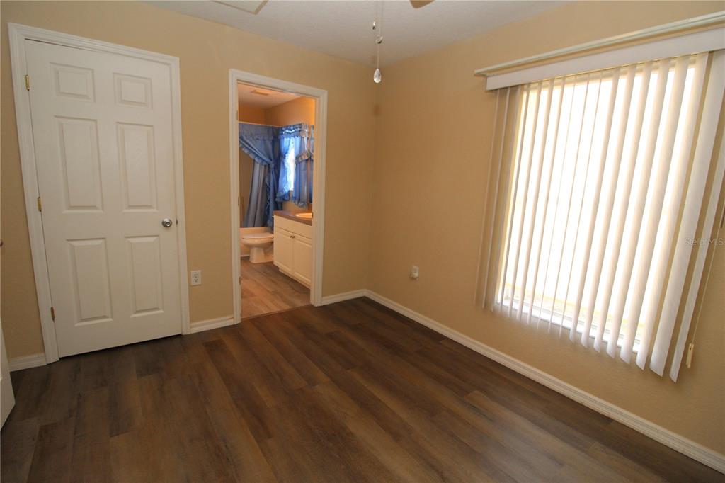 7432 Perennial Road North Port, FL 34291 - Photo 48 of 61 a view of an empty room with wooden floor and a window