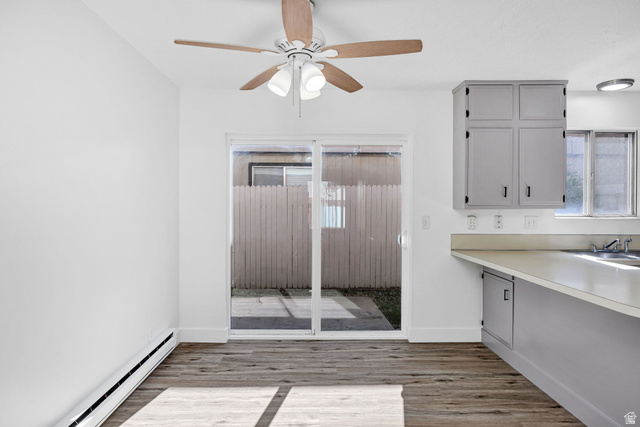 283 West 600 North, Unit 2 Logan, UT 84321 - Photo 11 of 36 Interior space featuring wood-finish flooring, white walls, and a ceiling fan with light fixture