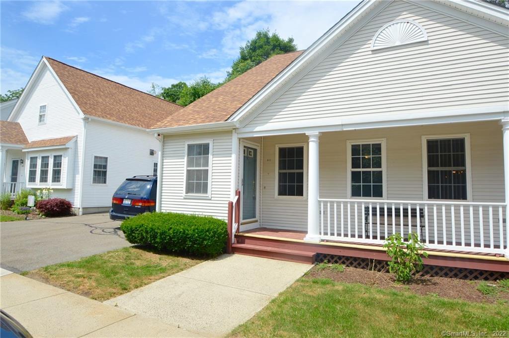 a view of a house with a small yard and wooden fence