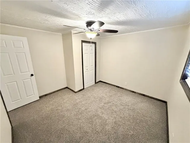 an empty room with windows and closet
