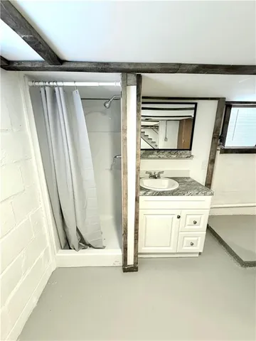 a bathroom with a granite countertop sink a toilet and a mirror