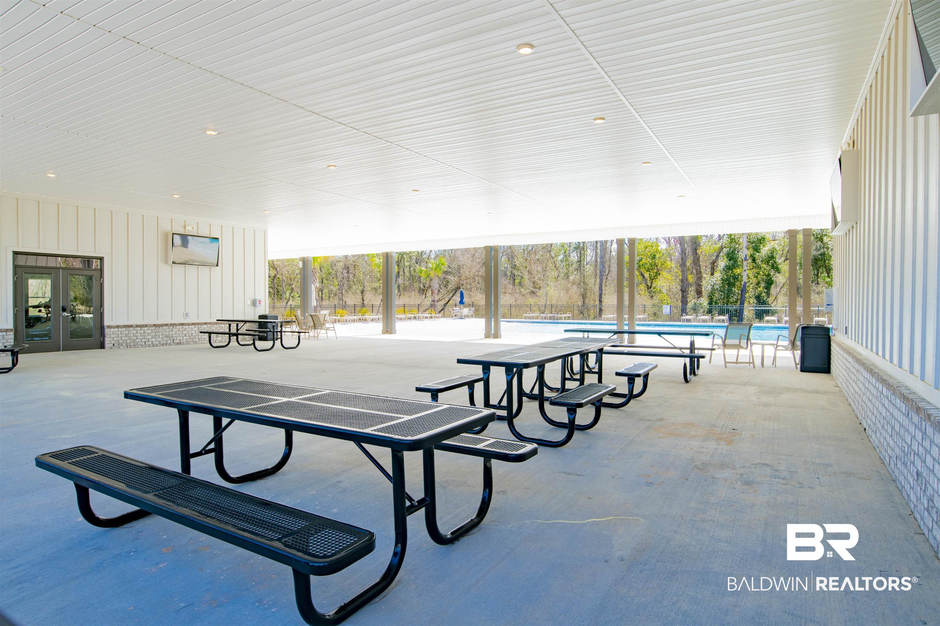 22301 Early Dawn Circle Foley, AL 36535 - Photo 40 of 45 Covered patio area featuring concrete flooring, white board-and-batten style siding, and recessed lighting