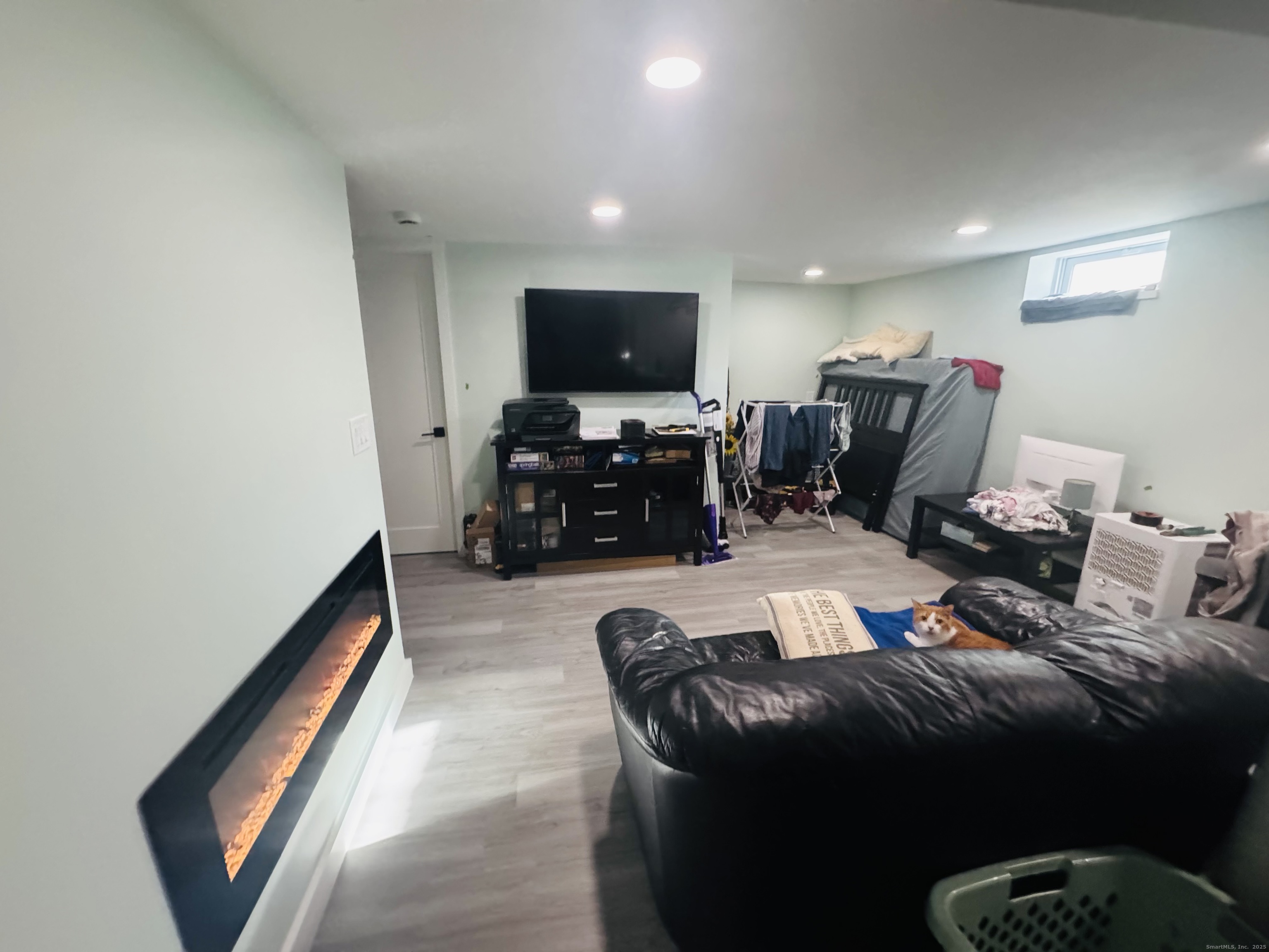 205 Ballamahack Road Windham, CT 06280 - Photo 16 of 29 a living room with furniture a flat screen tv and a window