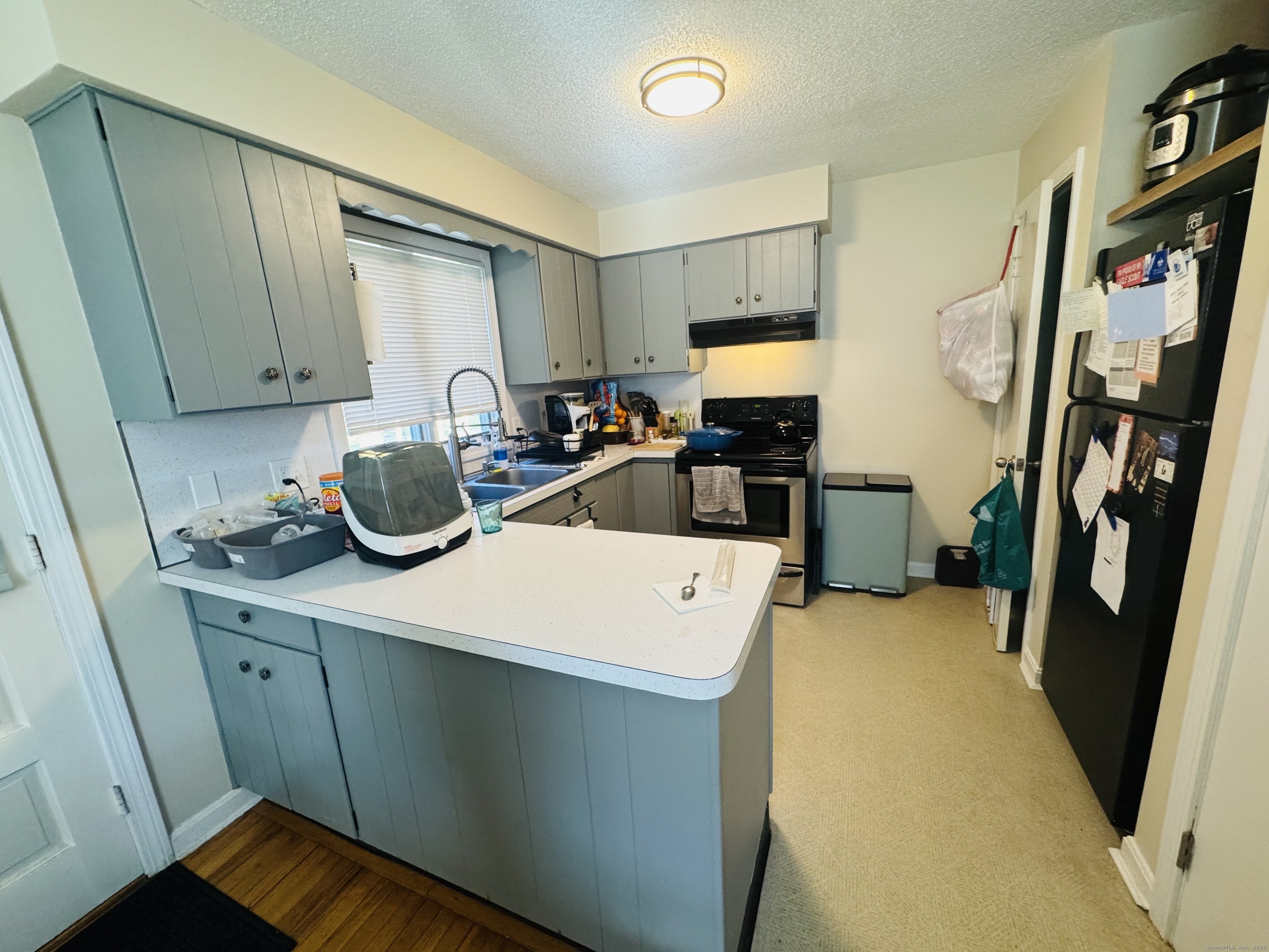 205 Ballamahack Road Windham, CT 06280 - Photo 18 of 29 a view of a kitchen with fridge and workspace