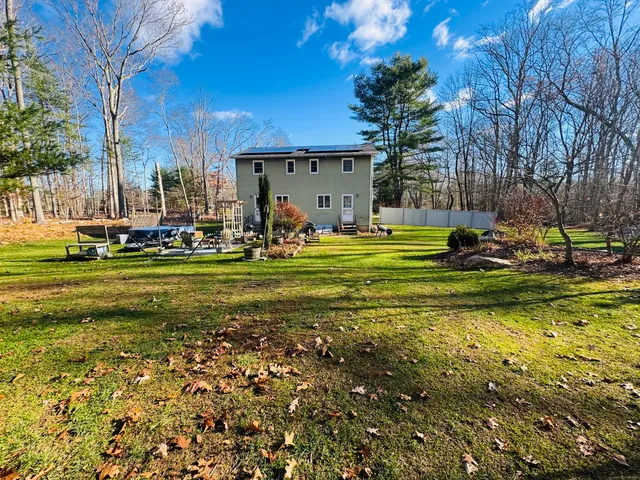 a view of a patio with a table and chairs and potted plants