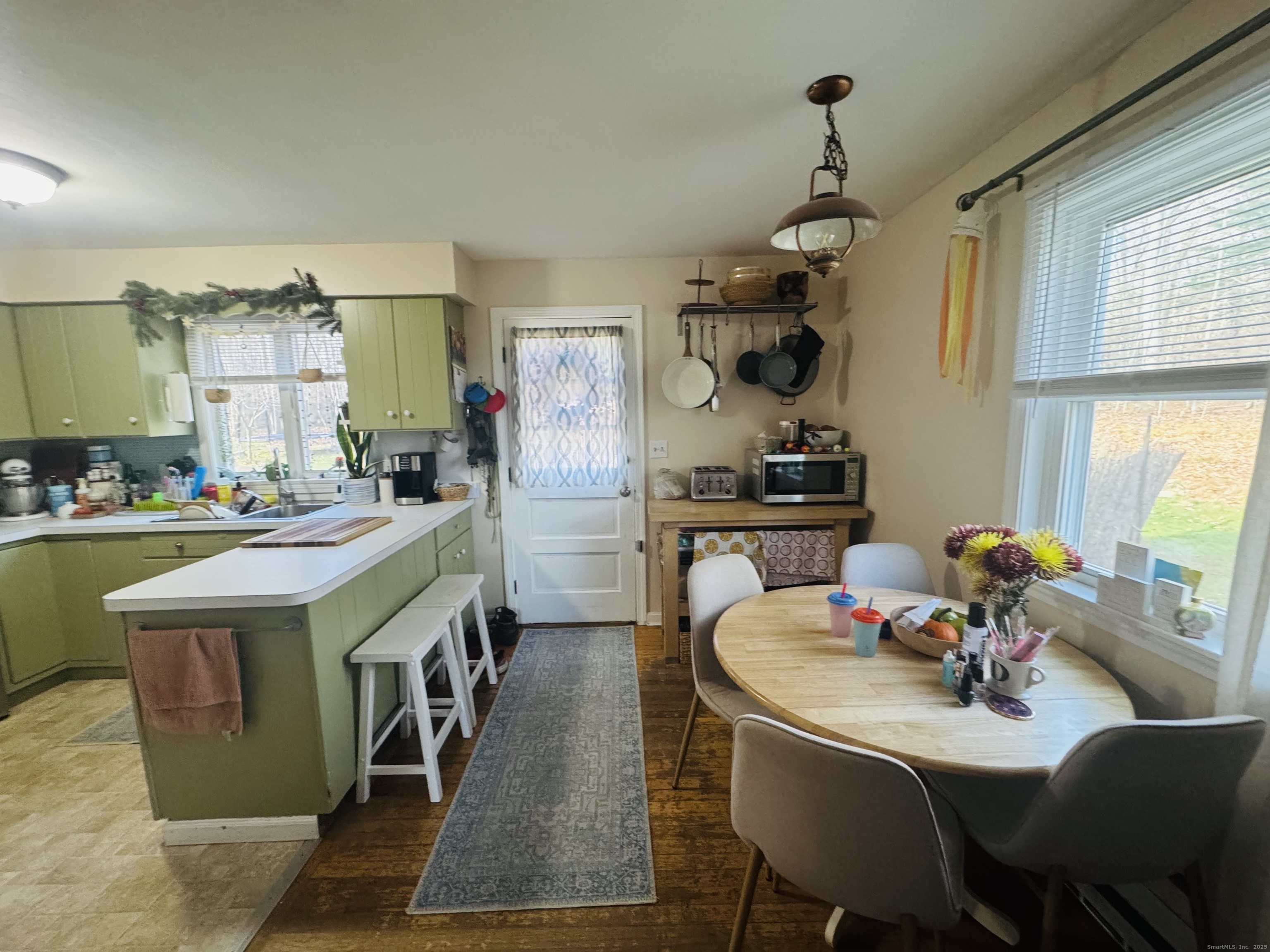 205 Ballamahack Road Windham, CT 06280 - Photo 23 of 29 a dining room with wooden floor and large windows