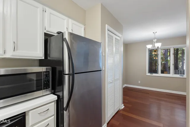 a kitchen with a sink cabinets and stainless steel appliances