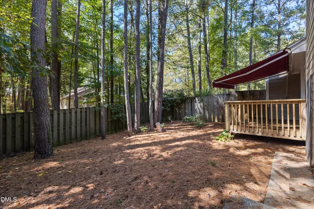 a view of small house with a yard