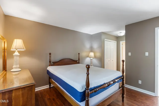 a bed sitting in a bedroom next to a window