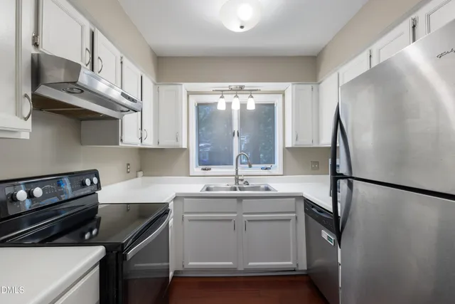 a view of a room with wooden floor and a window