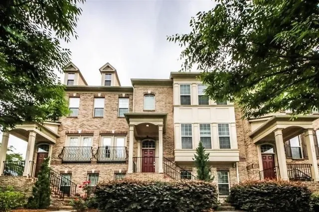 a front view of a residential apartment building with a yard