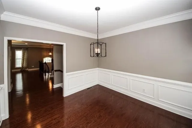 a view of a room with wooden floor closet and windows