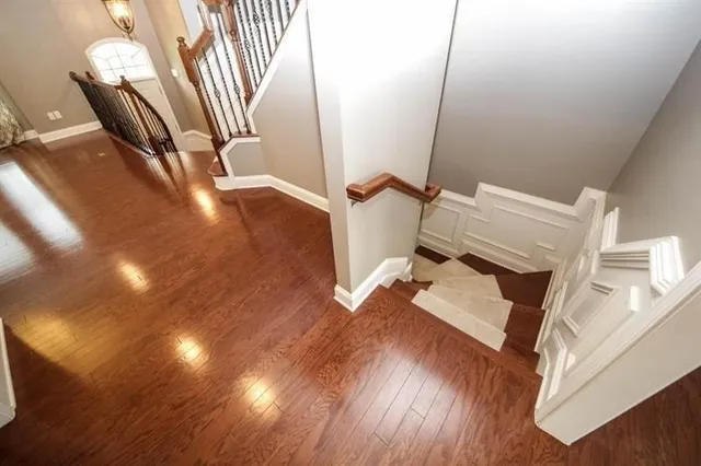 a view of entryway and hall with wooden floor