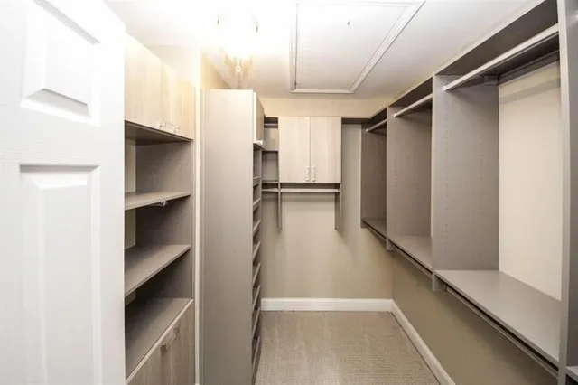 a view of walk in closet with empty racks