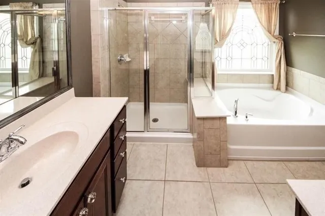 a bathroom with a tub sink and mirror