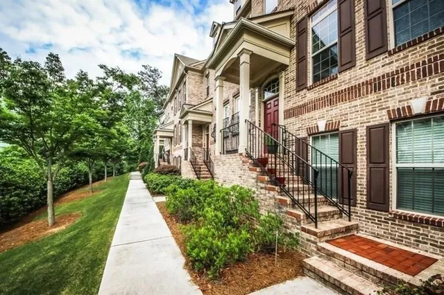 a front view of a building with a garden