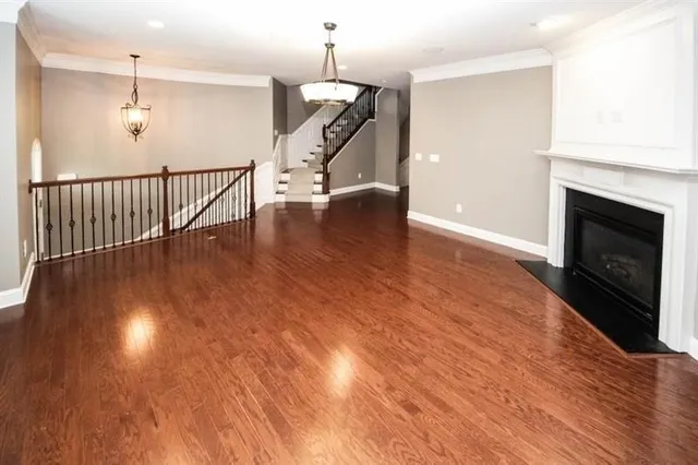 a view of a livingroom with wooden floor and a fireplace