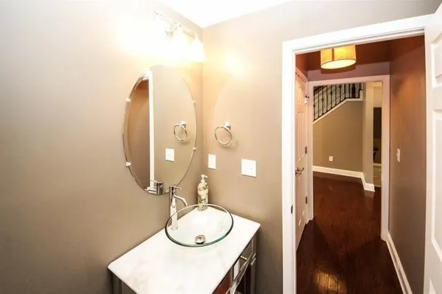 a bathroom with a sink a mirror and a shower