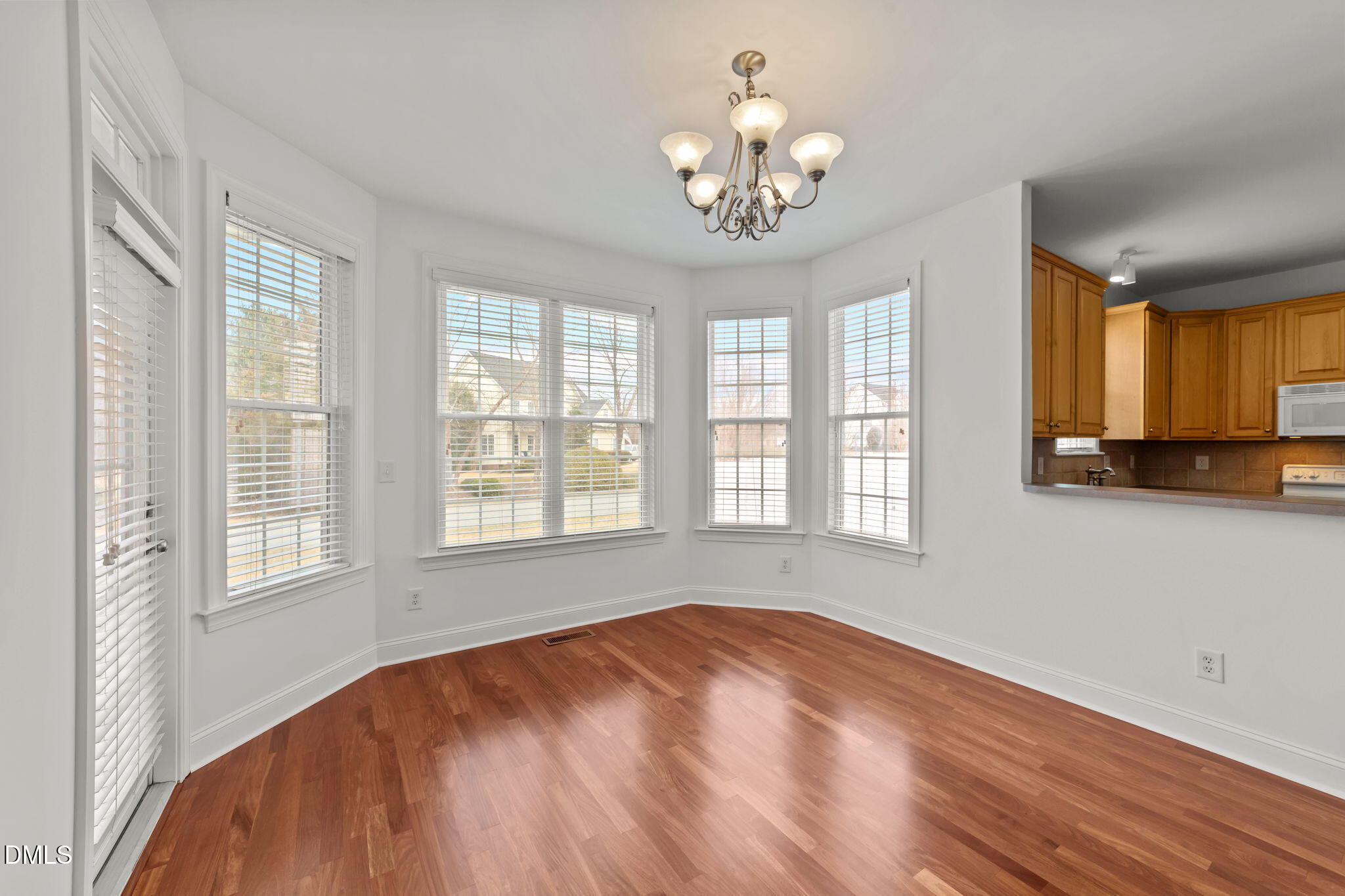 7101 Numa Circle Willow Spring, NC 27592 - Photo 8 of 44 a view of an empty room with a window and wooden floor