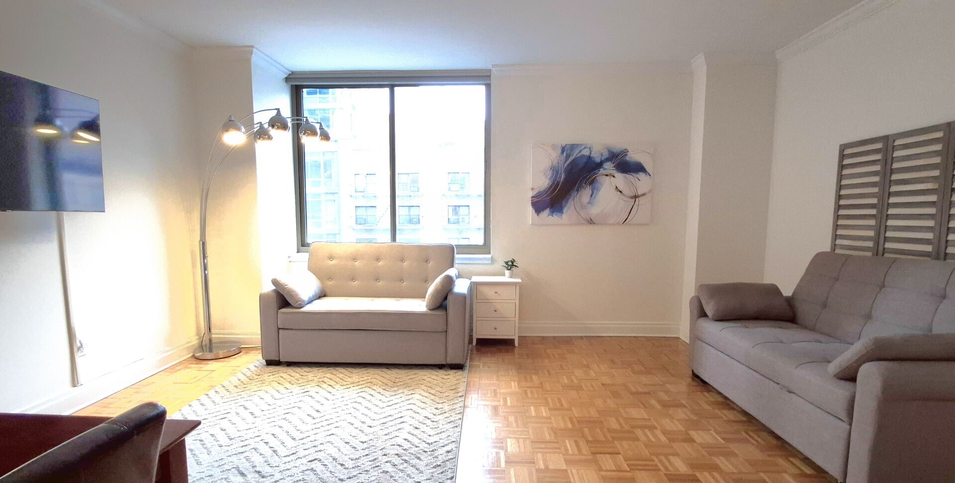 400 East 90th Street, Unit 4D Manhattan, NY 10128 - Photo 3 of 12 a living room with furniture and a large window
