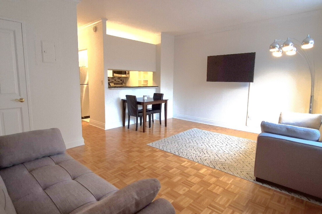 400 East 90th Street, Unit 4D Manhattan, NY 10128 - Photo 4 of 12 a living room with furniture and a flat screen tv