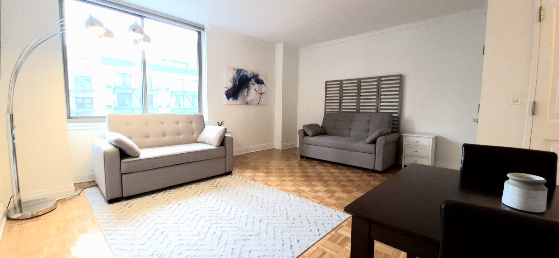 400 East 90th Street, Unit 4D Manhattan, NY 10128 - Photo 5 of 12 a living room with furniture and a large window