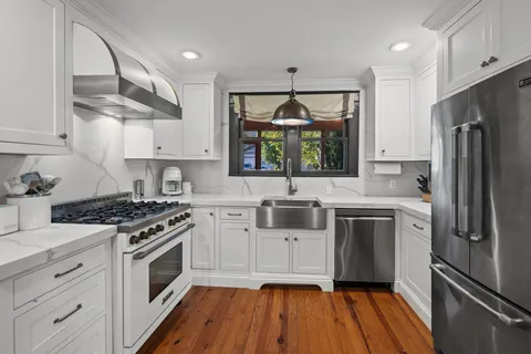 a kitchen with a stove a sink and a refrigerator