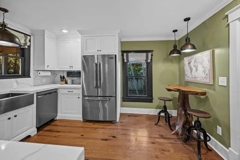 a kitchen with a refrigerator a sink and cabinets