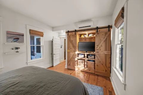 a bedroom with a bed and a flat screen tv