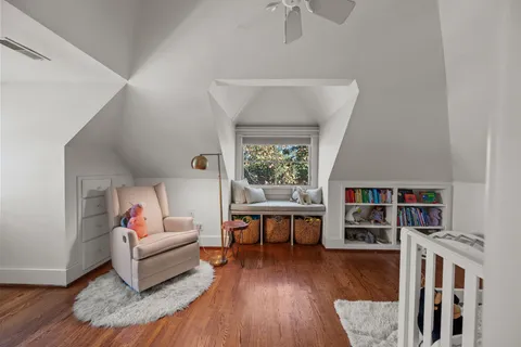 a living room with furniture and a book shelf