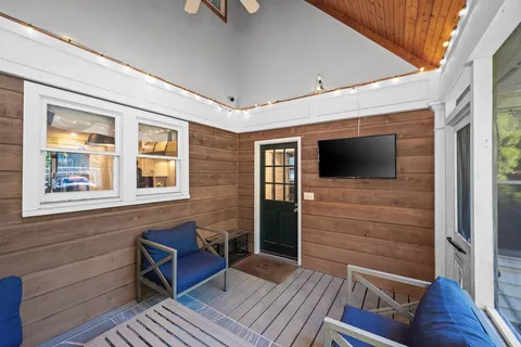 a view of a livingroom with wooden floor and furniture