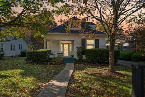 a front view of house with yard and green space