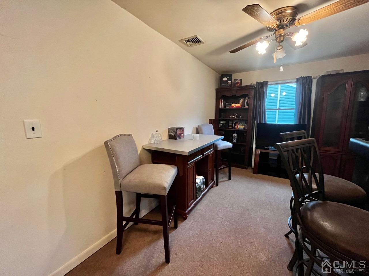180 Amboy Road Old Bridge, NJ 07747 - Photo 11 of 29 a view of a workspace with furniture and chandelier fan