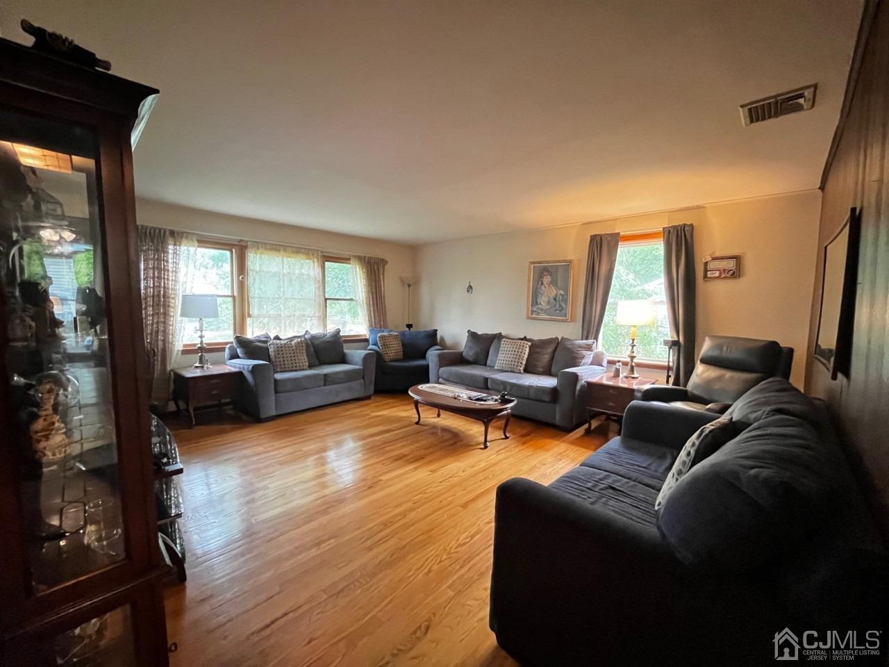 180 Amboy Road Old Bridge, NJ 07747 - Photo 13 of 29 a living room with furniture and a large window