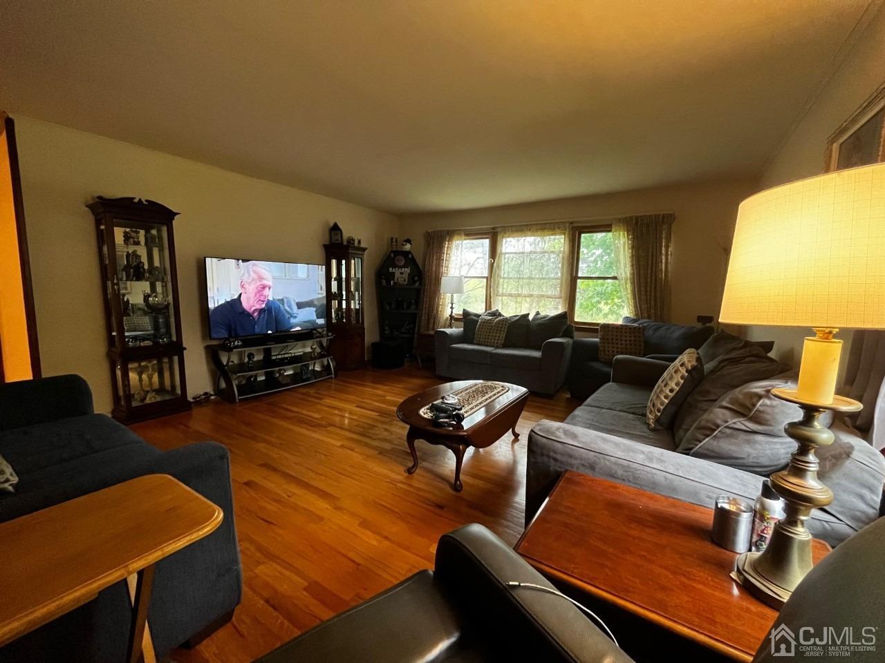 180 Amboy Road Old Bridge, NJ 07747 - Photo 14 of 29 a living room with furniture and a flat screen tv