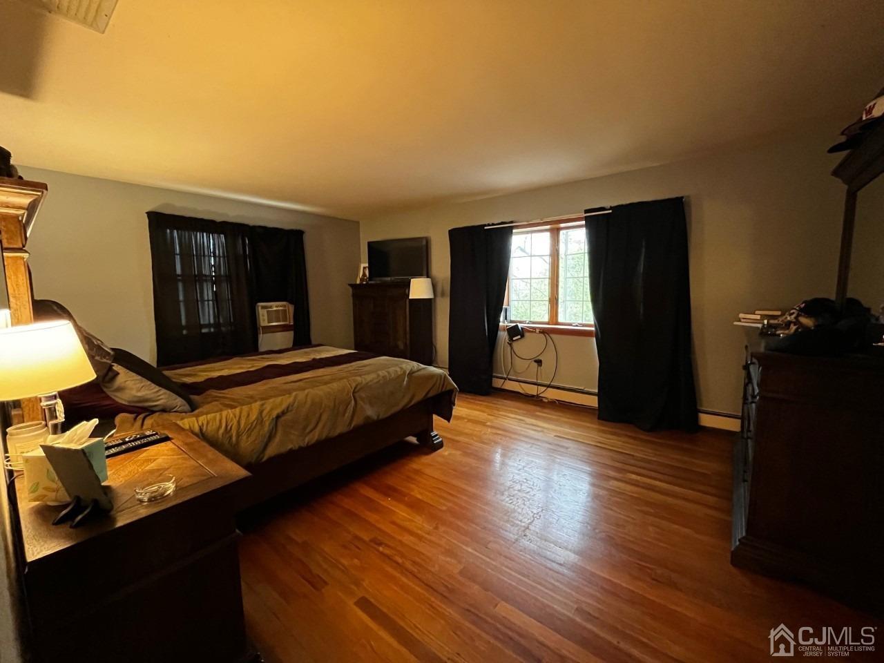 180 Amboy Road Old Bridge, NJ 07747 - Photo 21 of 29 a bedroom with a bed and wooden floor
