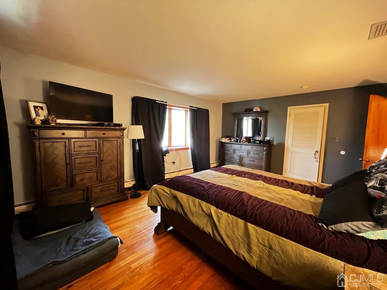 180 Amboy Road Old Bridge, NJ 07747 - Photo 23 of 29 a spacious bedroom with a bed and a television in it