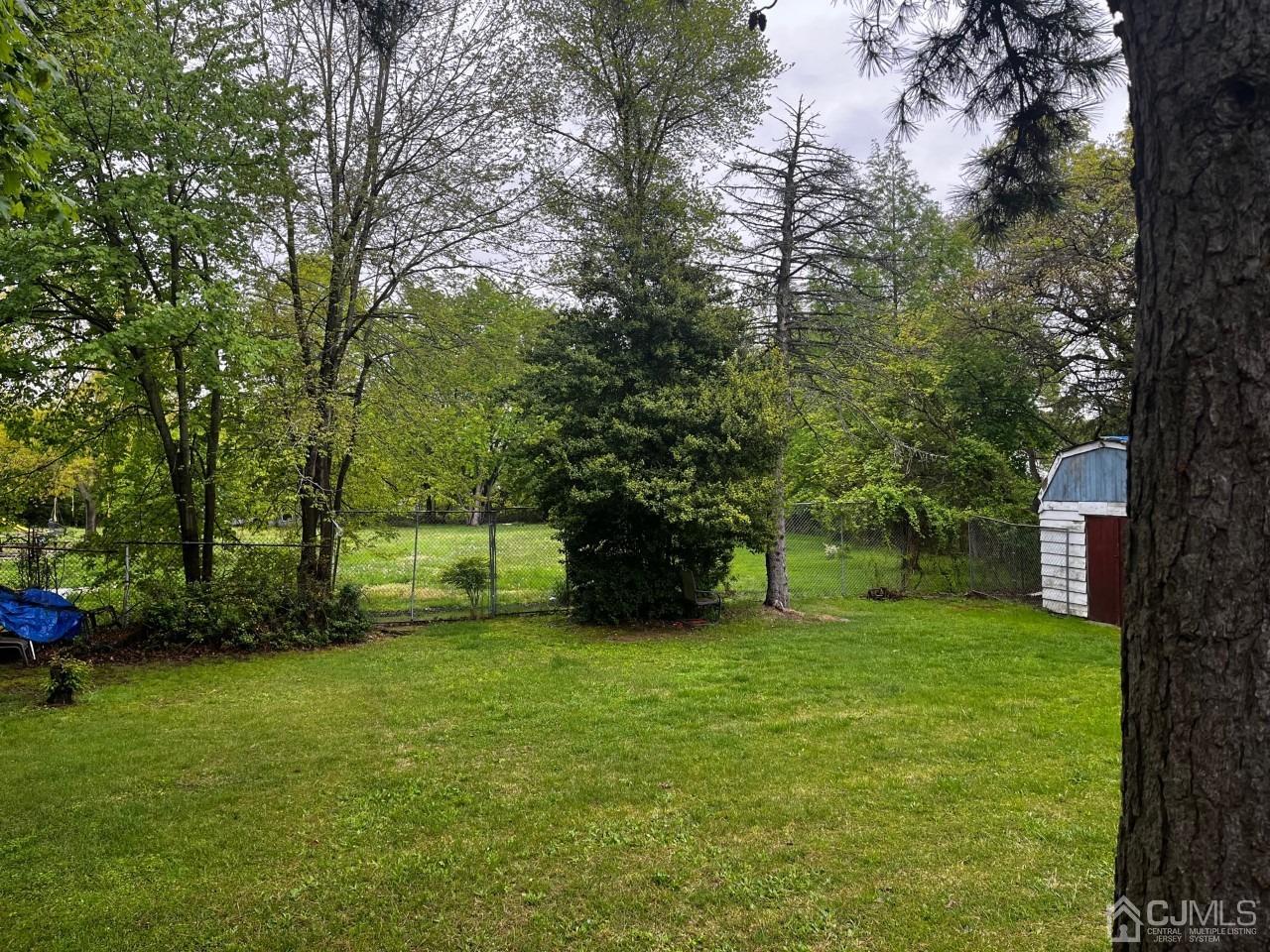 180 Amboy Road Old Bridge, NJ 07747 - Photo 26 of 29 a big yard with lots of green space and trees