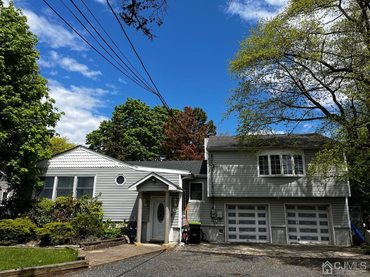 180 Amboy Road Old Bridge, NJ 07747 - Photo 3 of 29 a front view of a house with a garden