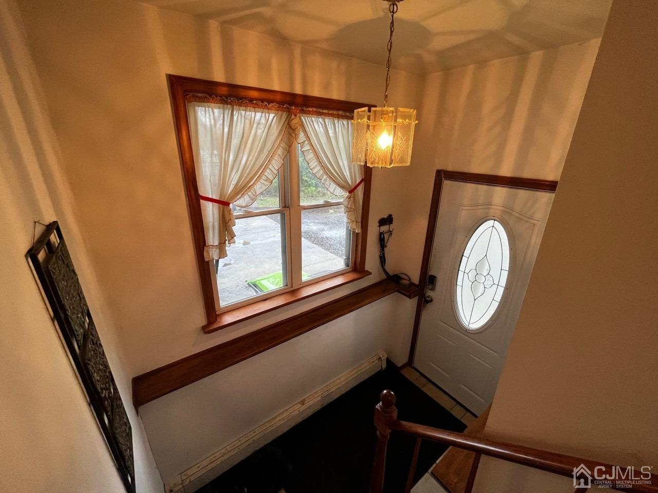 180 Amboy Road Old Bridge, NJ 07747 - Photo 4 of 29 a view of staircase with a large mirror and a window