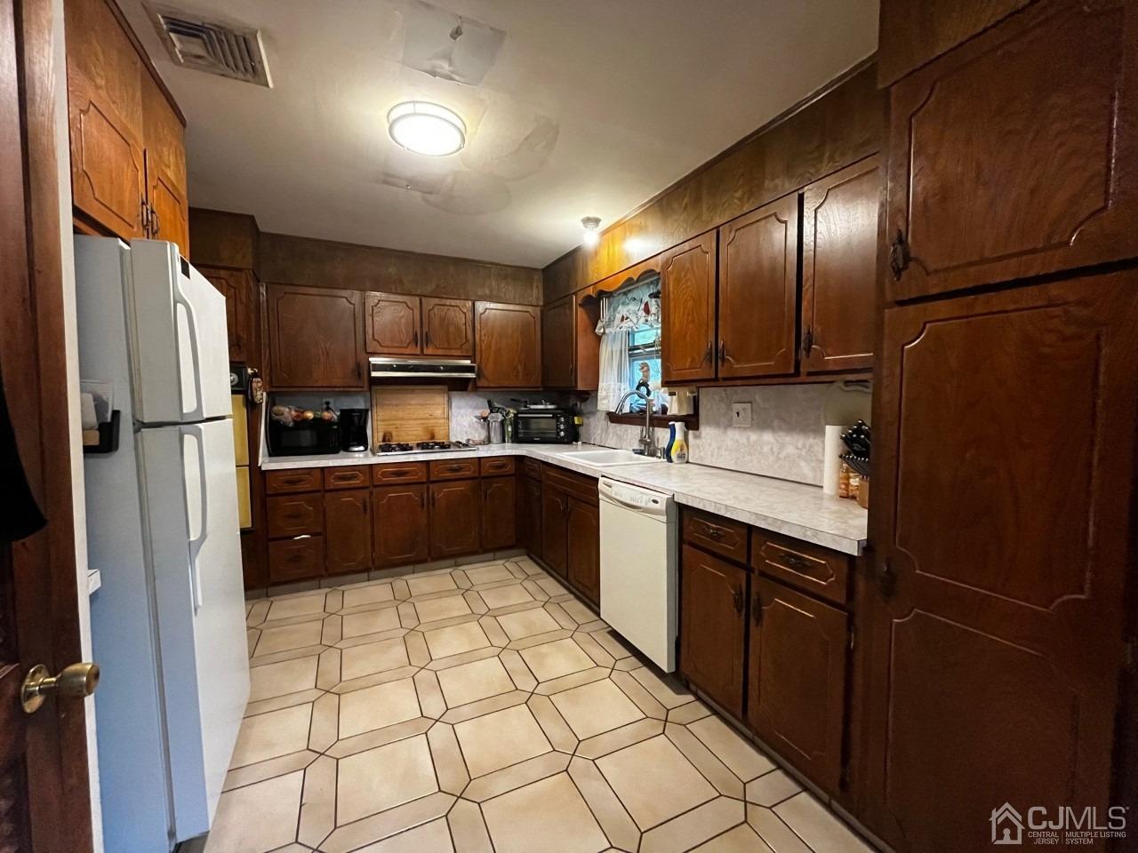 180 Amboy Road Old Bridge, NJ 07747 - Photo 6 of 29 a kitchen with stainless steel appliances a refrigerator sink and cabinets