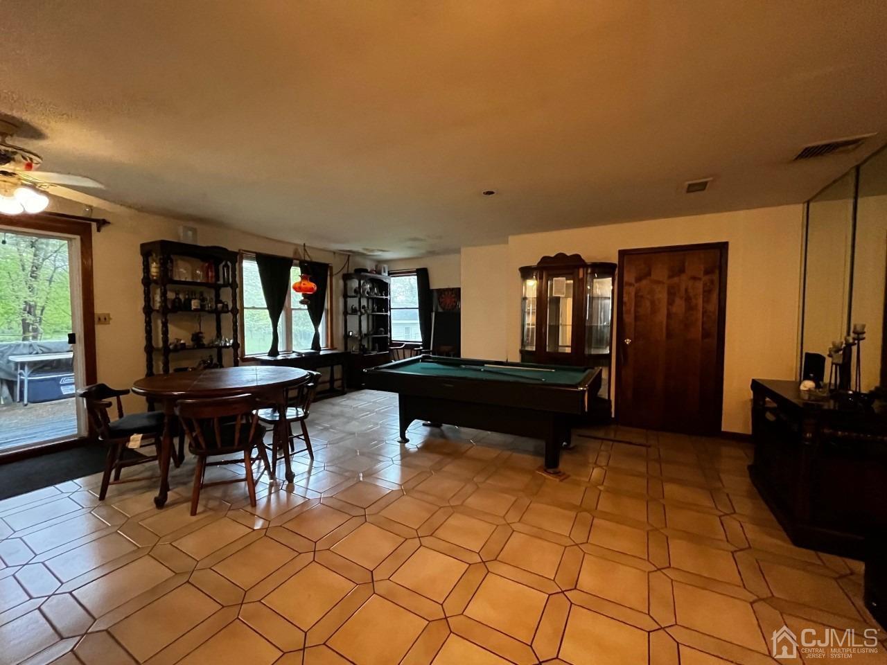 180 Amboy Road Old Bridge, NJ 07747 - Photo 10 of 29 a living room with furniture a piano and a potted plant