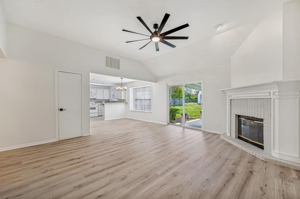 629 Concho Drive Oak Point, TX 75068 - Photo 6 of 35 an empty room with windows and a fireplace