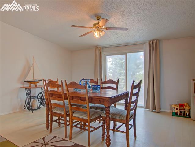 890 Ranchette Place Calhan, CO 80808 - Photo 12 of 26 The dining room off the kitchen. The sliding door exits onto the patio to the west.