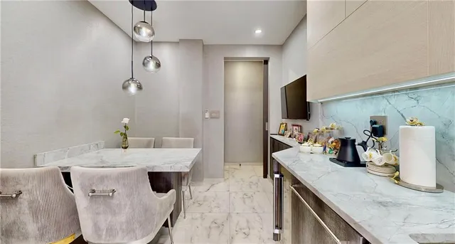 a kitchen with stainless steel appliances kitchen island granite countertop a refrigerator a sink a stove and island